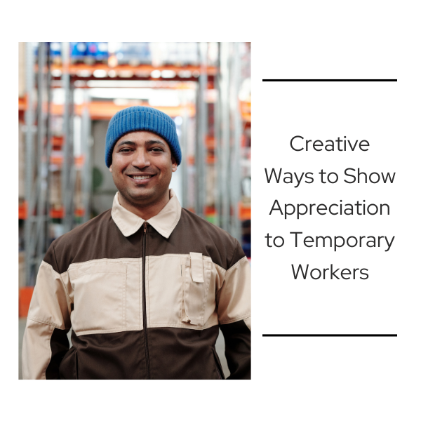 Smiling warehouse employee wearing a blue beanie and uniform stands in front of storage racks, representing appreciation and recognition for temporary workers.